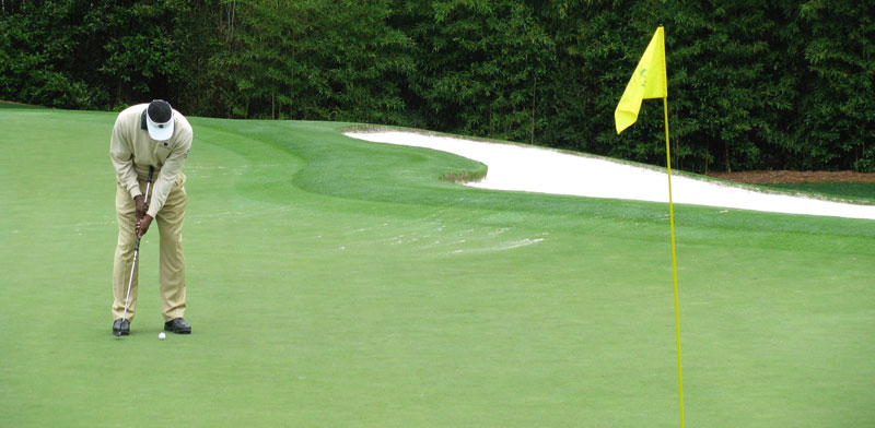 Masters Golf Tournament Player making a putt on the famous Augusta National Golf Course